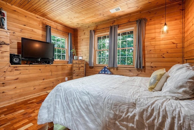 647 Omega Dr, Spring City, TN 37381 - bedroom with wooden walls, wood finished floors, and wood ceiling