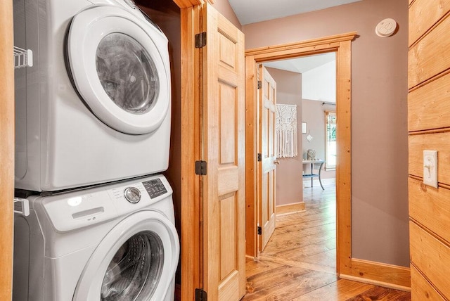 647 Omega Dr, Spring City, TN 37381 - laundry room with stacked washer and clothes dryer and light wood-type flooring