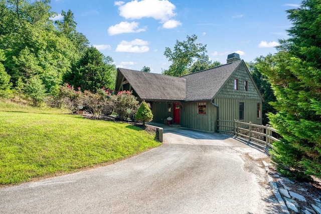 647 Omega Dr, Spring City, TN 37381 - view of front of house with roof with shingles, a front yard, board and batten siding, asphalt driveway, and a chimney