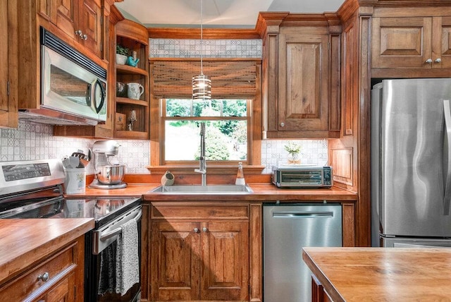 647 Omega Dr, Spring City, TN 37381 - kitchen featuring stainless steel appliances, butcher block counters, and brown cabinetry