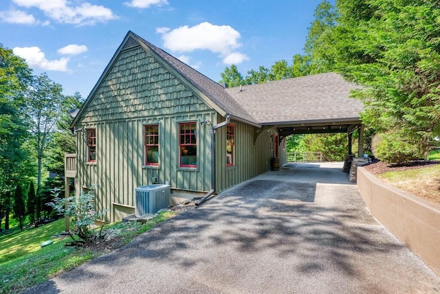 647 Omega Dr, Spring City, TN 37381 - view of front of property with driveway, board and batten siding, and an attached carport
