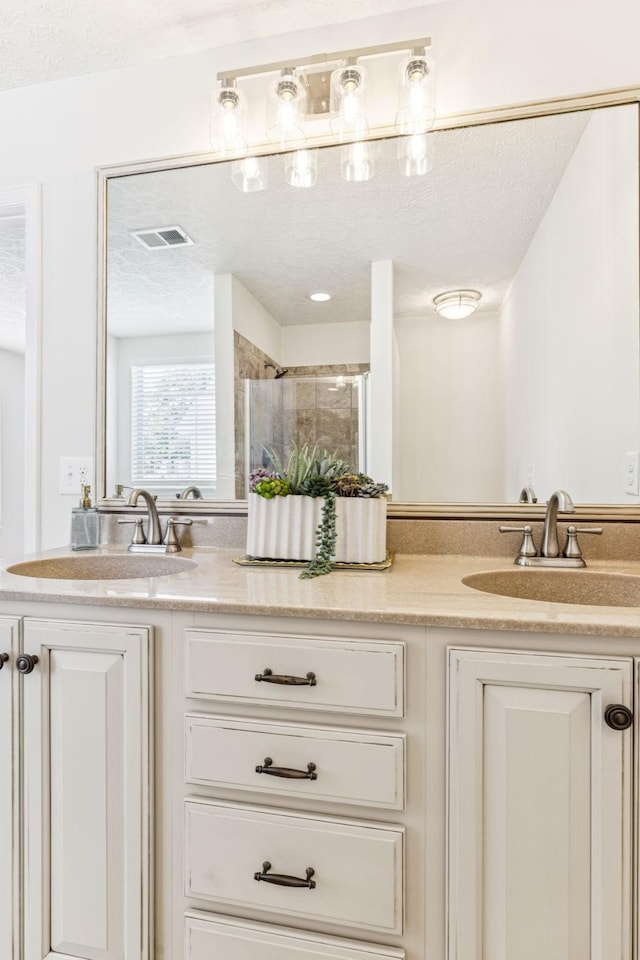 3037 Wilcot Way, Franklin, TN 37069 - full bathroom with double vanity, a shower stall, and a textured ceiling