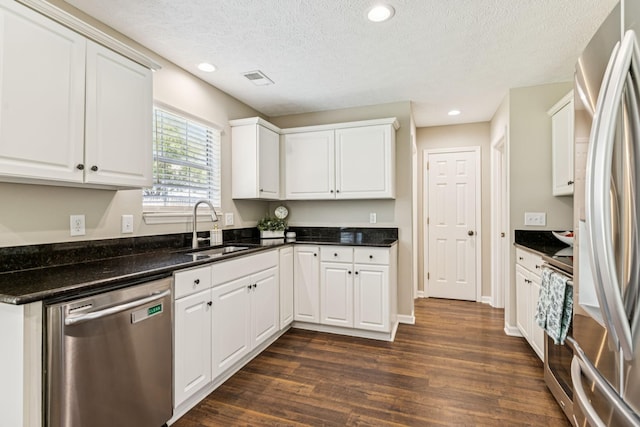3037 Wilcot Way, Franklin, TN 37069 - kitchen featuring appliances with stainless steel finishes, dark wood-style floors, white cabinetry, a textured ceiling, and recessed lighting