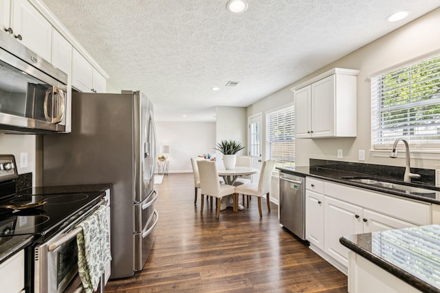 3037 Wilcot Way, Franklin, TN 37069 - kitchen with stainless steel appliances, dark wood-style flooring, white cabinetry, a textured ceiling, and recessed lighting