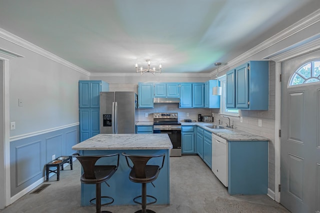 5334 Shelbyville Pike, Christiana, TN 37037 - kitchen with blue cabinetry, stainless steel appliances, under cabinet range hood, a chandelier, and a center island