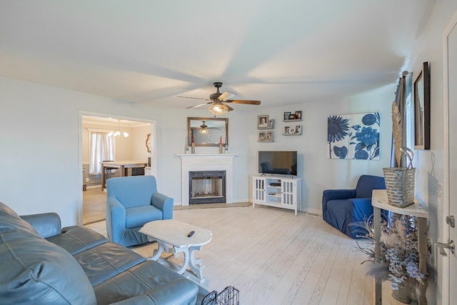 5334 Shelbyville Pike, Christiana, TN 37037 - living room featuring a ceiling fan, a glass covered fireplace, and light wood-style flooring