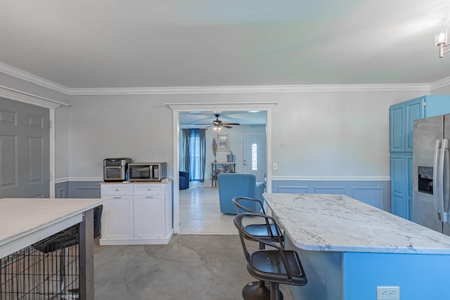 5334 Shelbyville Pike, Christiana, TN 37037 - kitchen with stainless steel appliances, ornamental molding, ceiling fan, light stone counters, and wainscoting