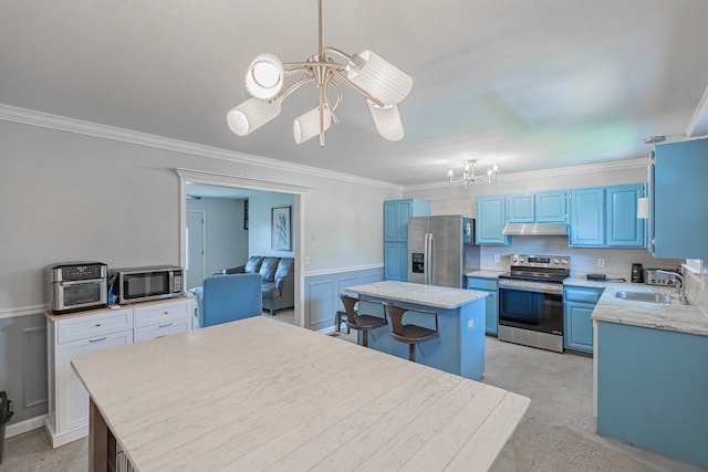 5334 Shelbyville Pike, Christiana, TN 37037 - kitchen with appliances with stainless steel finishes, a chandelier, under cabinet range hood, blue cabinets, and crown molding