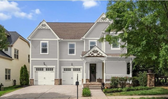 1000 Swanson Ln, Franklin, TN 37064 - view of front of home with driveway, an attached garage, and covered porch