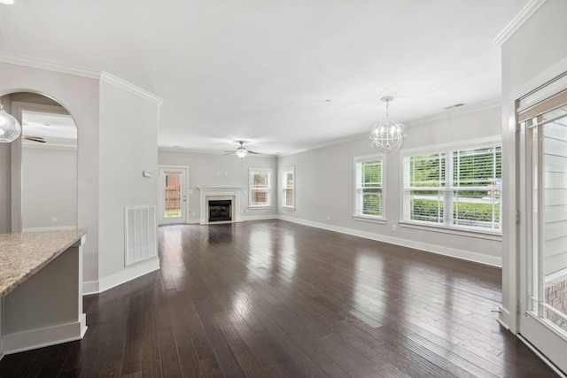 1000 Swanson Ln, Franklin, TN 37064 - unfurnished living room featuring a ceiling fan, dark wood-style floors, a fireplace, arched walkways, and a chandelier