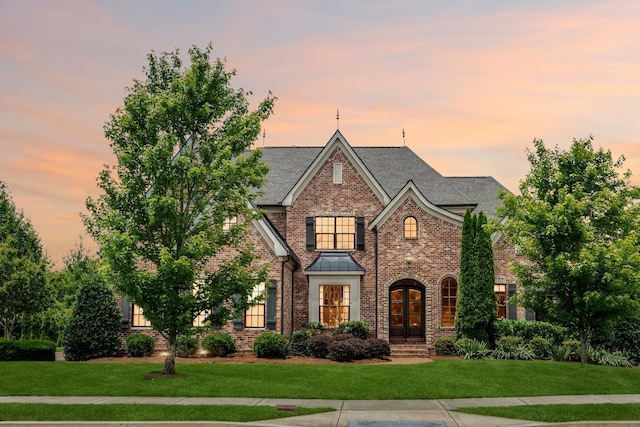 1825 Barnstaple Ln, Brentwood, TN 37027 - view of front of home with brick siding, a front yard, a standing seam roof, and roof with shingles