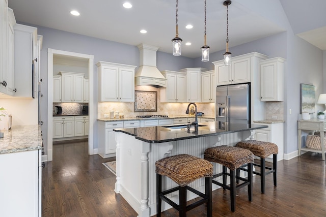 1825 Barnstaple Ln, Brentwood, TN 37027 - kitchen with appliances with stainless steel finishes, custom exhaust hood, tasteful backsplash, recessed lighting, and a kitchen island with sink