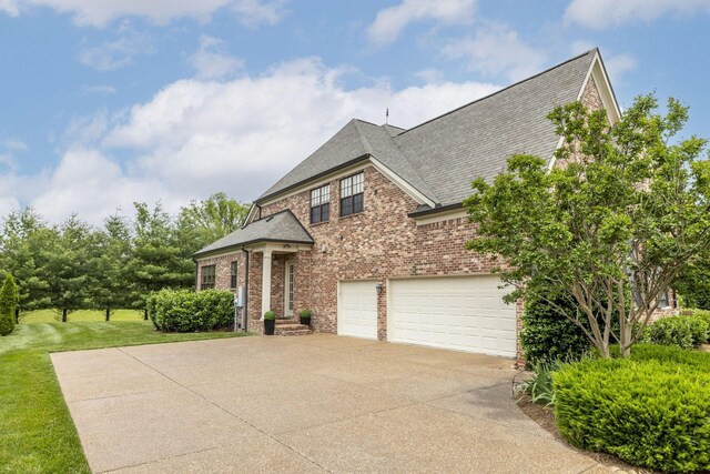 1825 Barnstaple Ln, Brentwood, TN 37027 - view of front of home with driveway, roof with shingles, brick siding, and a garage