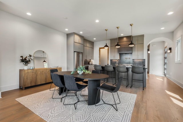 2118 Cliff Dr, Nashville, TN 37218 - dining space featuring arched walkways, recessed lighting, and light wood finished floors