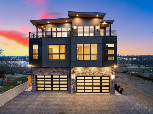 2118 Cliff Dr, Nashville, TN 37218 - contemporary house with a balcony, stone siding, a garage, and decorative driveway
