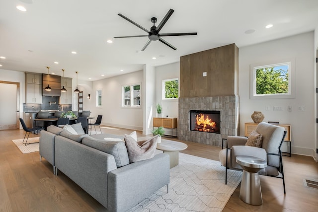2118 Cliff Dr, Nashville, TN 37218 - living room with light wood-type flooring, a tile fireplace, ceiling fan, and recessed lighting