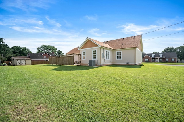 2606 Battleground Dr, Murfreesboro, TN 37129 - rear view of house featuring stucco siding, a storage shed, and roof with shingles
