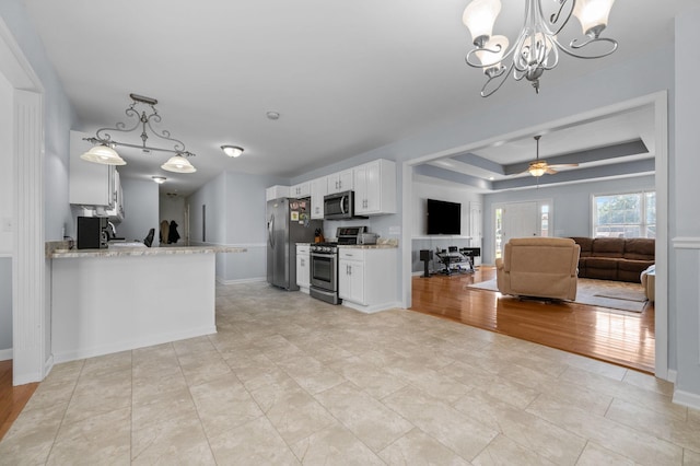 2606 Battleground Dr, Murfreesboro, TN 37129 - kitchen featuring stainless steel appliances, white cabinets, a ceiling fan, a chandelier, and a tray ceiling
