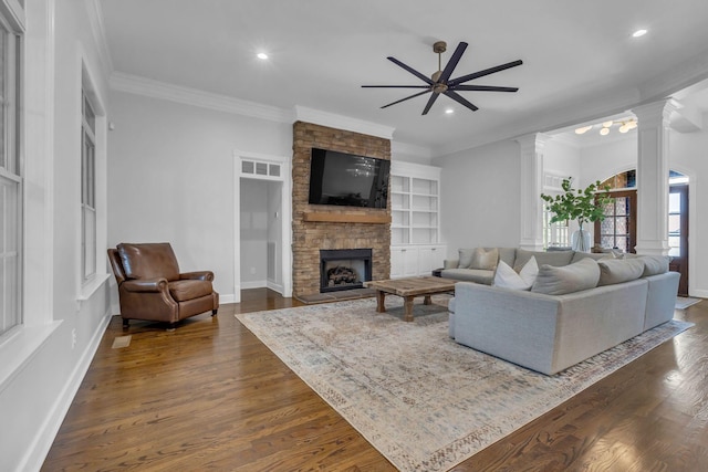 1803 Benziger Ter, Brentwood, TN 37027 - living area with ornate columns, ornamental molding, dark wood-type flooring, a fireplace, and ceiling fan