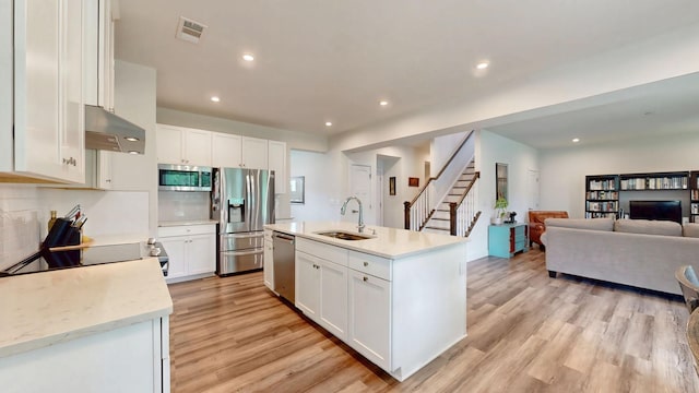 3428 Pepper Glendale Dr, Murfreesboro, TN 37128 - kitchen featuring appliances with stainless steel finishes, exhaust hood, light wood-type flooring, open floor plan, and white cabinetry