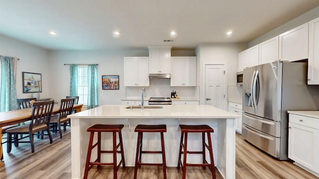3428 Pepper Glendale Dr, Murfreesboro, TN 37128 - kitchen with stainless steel appliances, a kitchen island with sink, light wood-style flooring, backsplash, and white cabinets