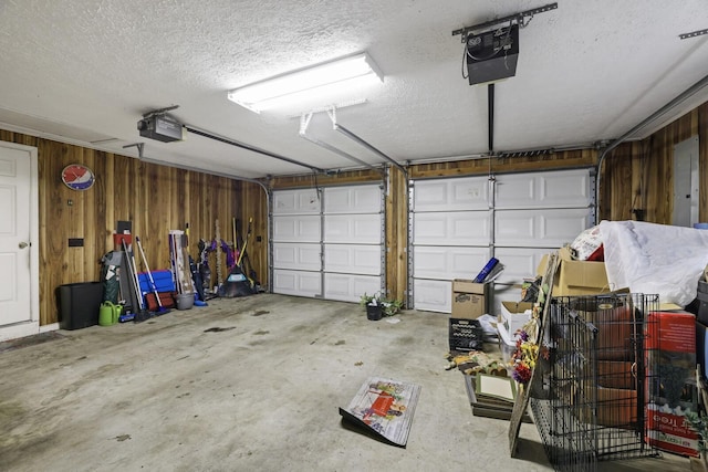 144 Waggoner St, Carthage, TN 37030 - garage featuring a garage door opener, wooden walls, and electric panel