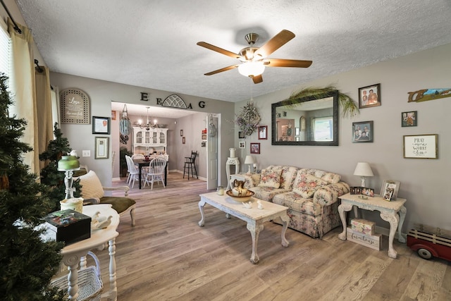 144 Waggoner St, Carthage, TN 37030 - living area with a textured ceiling, wood finished floors, ceiling fan, and a chandelier