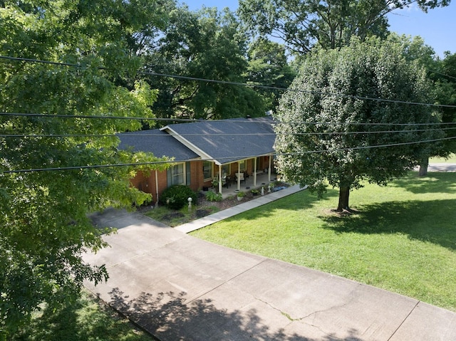 144 Waggoner St, Carthage, TN 37030 - ranch-style house featuring a porch, a front yard, and concrete driveway