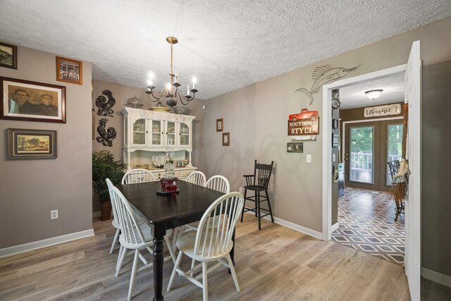 144 Waggoner St, Carthage, TN 37030 - dining area featuring a chandelier, a textured ceiling, and light wood finished floors
