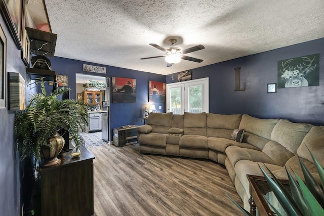 144 Waggoner St, Carthage, TN 37030 - living room with wood finished floors, a ceiling fan, and a textured ceiling