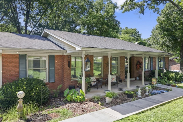 144 Waggoner St, Carthage, TN 37030 - ranch-style house with a porch, brick siding, and roof with shingles