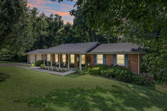 144 Waggoner St, Carthage, TN 37030 - ranch-style home with brick siding, a lawn, an attached garage, and asphalt driveway