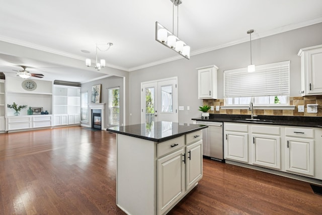 6014 Thrush Ct, Spring Hill, TN 37174 - kitchen featuring dishwasher, dark countertops, white cabinets, crown molding, and a center island
