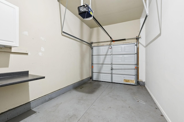 6014 Thrush Ct, Spring Hill, TN 37174 - garage featuring a garage door opener and baseboards