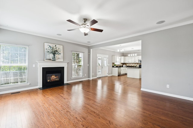6014 Thrush Ct, Spring Hill, TN 37174 - unfurnished living room featuring a ceiling fan, ornamental molding, dark wood-type flooring, and a fireplace with flush hearth