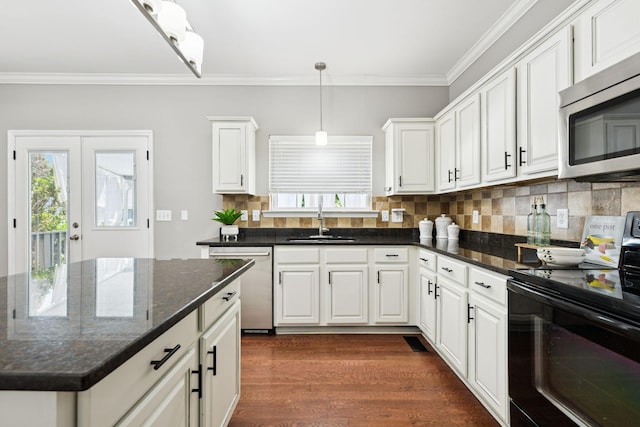 6014 Thrush Ct, Spring Hill, TN 37174 - kitchen featuring stainless steel appliances, ornamental molding, white cabinets, backsplash, and dark wood-style flooring