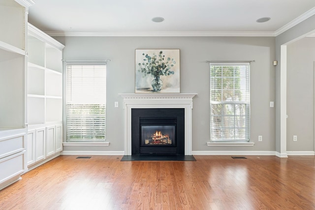 6014 Thrush Ct, Spring Hill, TN 37174 - unfurnished living room featuring a fireplace with flush hearth, wood finished floors, and ornamental molding