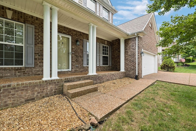 6014 Thrush Ct, Spring Hill, TN 37174 - entrance to property with covered porch, brick siding, an attached garage, and driveway