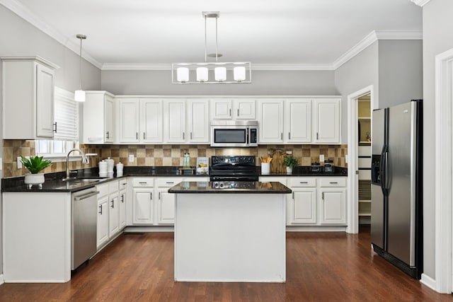 6014 Thrush Ct, Spring Hill, TN 37174 - kitchen featuring stainless steel appliances, dark countertops, white cabinets, dark wood-style floors, and ornamental molding