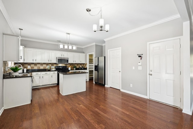 6014 Thrush Ct, Spring Hill, TN 37174 - kitchen featuring stainless steel appliances, dark countertops, a chandelier, white cabinetry, and a center island