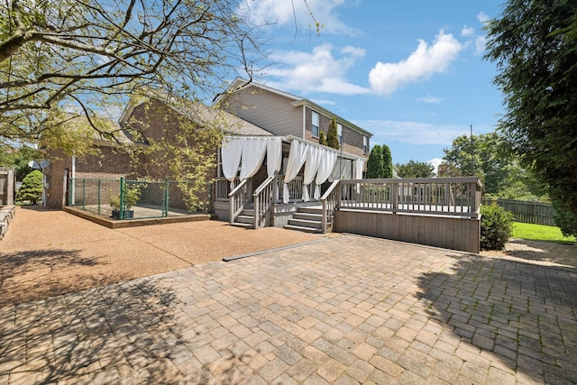6014 Thrush Ct, Spring Hill, TN 37174 - rear view of house with a deck, a patio area, and brick siding