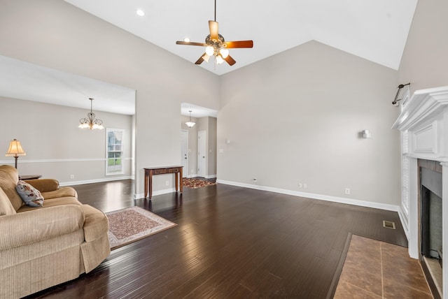3162 Cross Ridge Dr, Clarksville, TN 37040 - living room with ceiling fan, a fireplace with flush hearth, vaulted ceiling, wood-type flooring, and a chandelier