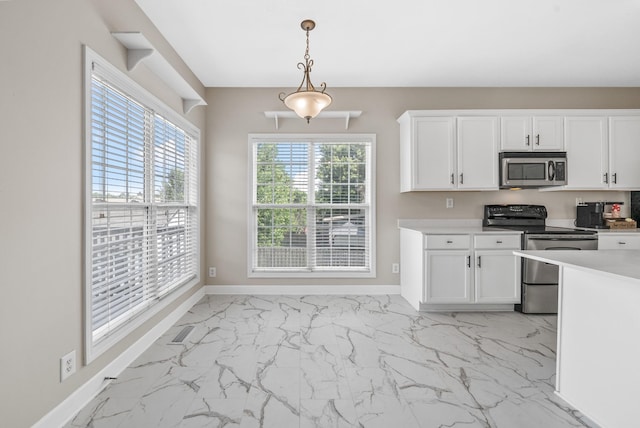 3162 Cross Ridge Dr, Clarksville, TN 37040 - kitchen with appliances with stainless steel finishes, light marble finish flooring, white cabinetry, hanging light fixtures, and light countertops