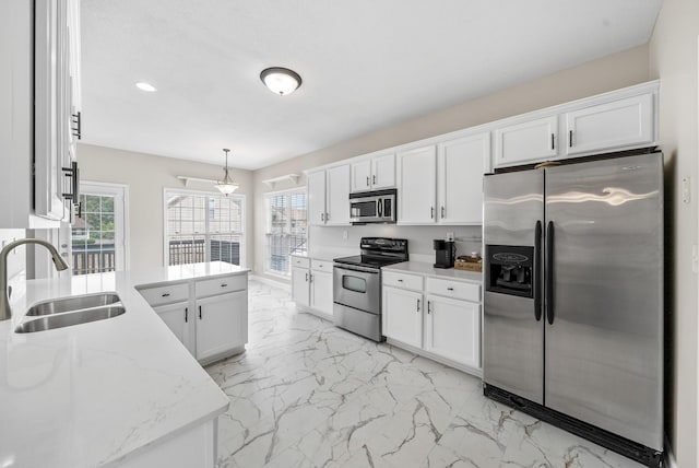 3162 Cross Ridge Dr, Clarksville, TN 37040 - kitchen with appliances with stainless steel finishes, light marble finish floors, white cabinetry, and recessed lighting