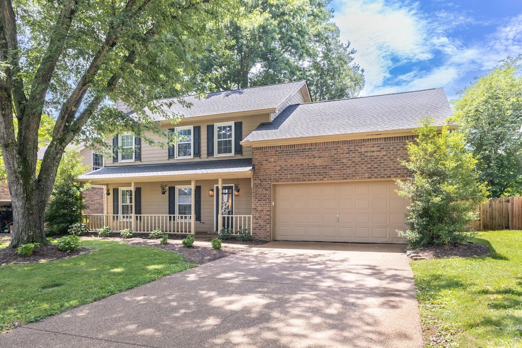 538 Maplegrove Dr, Franklin, TN 37064 - view of front of house with concrete driveway, covered porch, brick siding, roof with shingles, and a garage