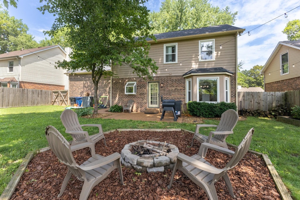 538 Maplegrove Dr, Franklin, TN 37064 - back of house with an outdoor fire pit, brick siding, a fenced backyard, and a patio area