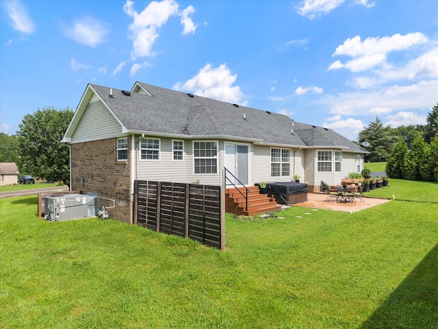 305 Davis Green Ln, Spring Hill, TN 37174 - back of property featuring a patio, a yard, a shingled roof, and brick siding