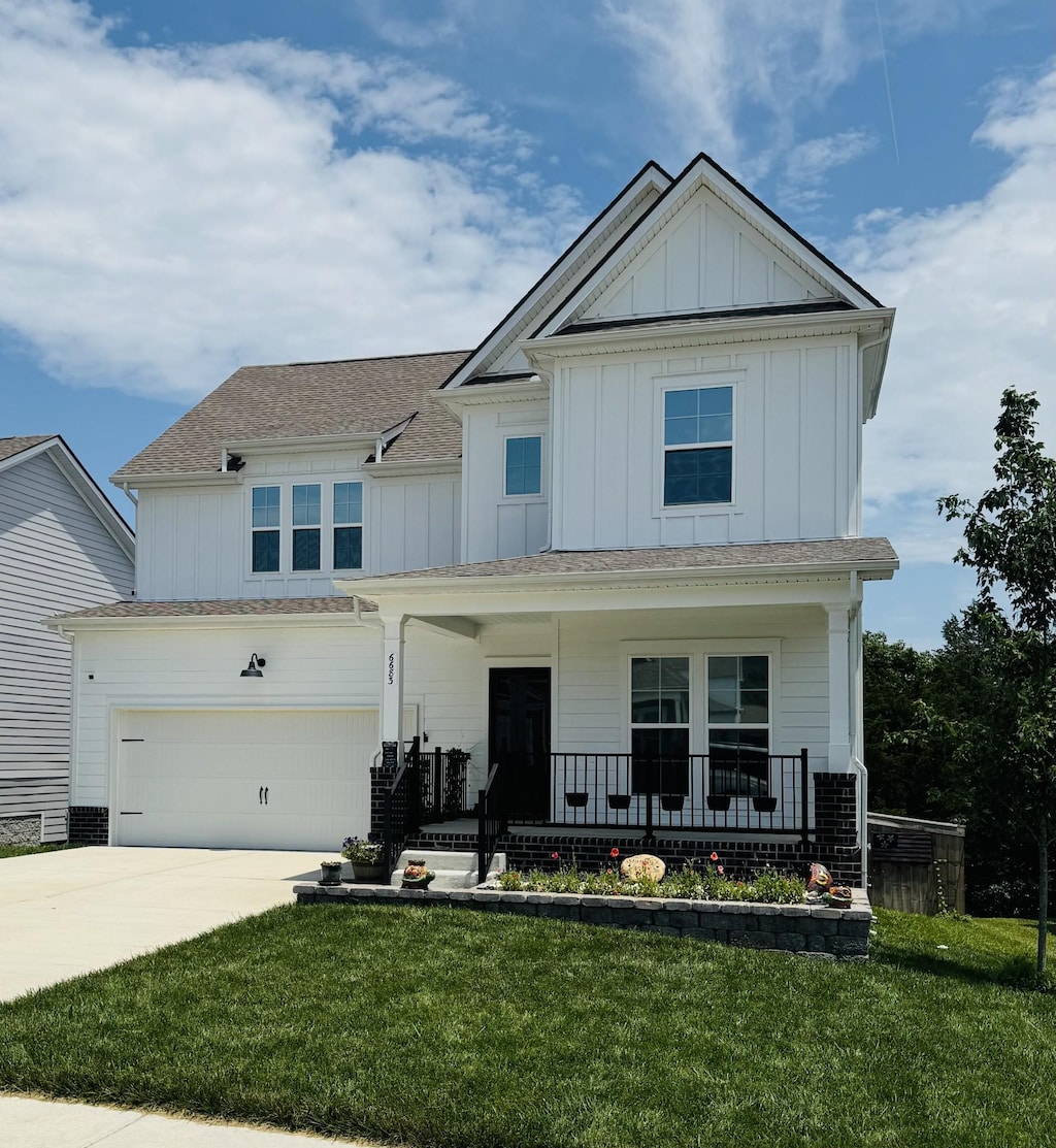 6683 Hanworth Trce, Smyrna, TN 37167 - view of front of house featuring board and batten siding, a porch, concrete driveway, and a front lawn