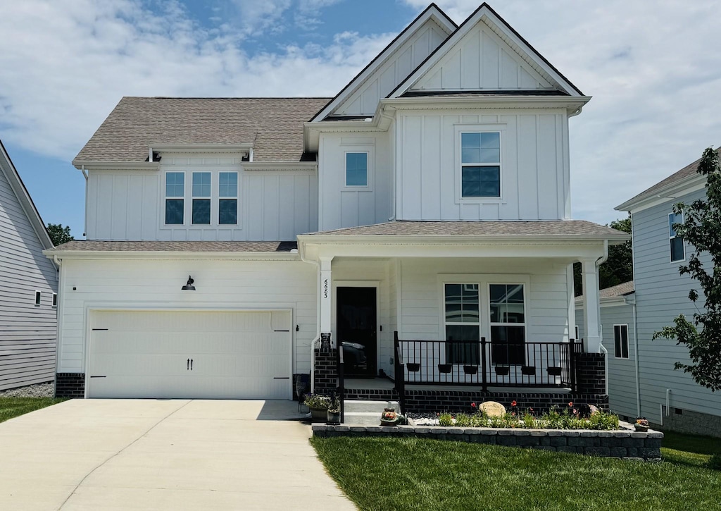 6683 Hanworth Trce, Smyrna, TN 37167 - view of front of house featuring covered porch, board and batten siding, driveway, and a garage