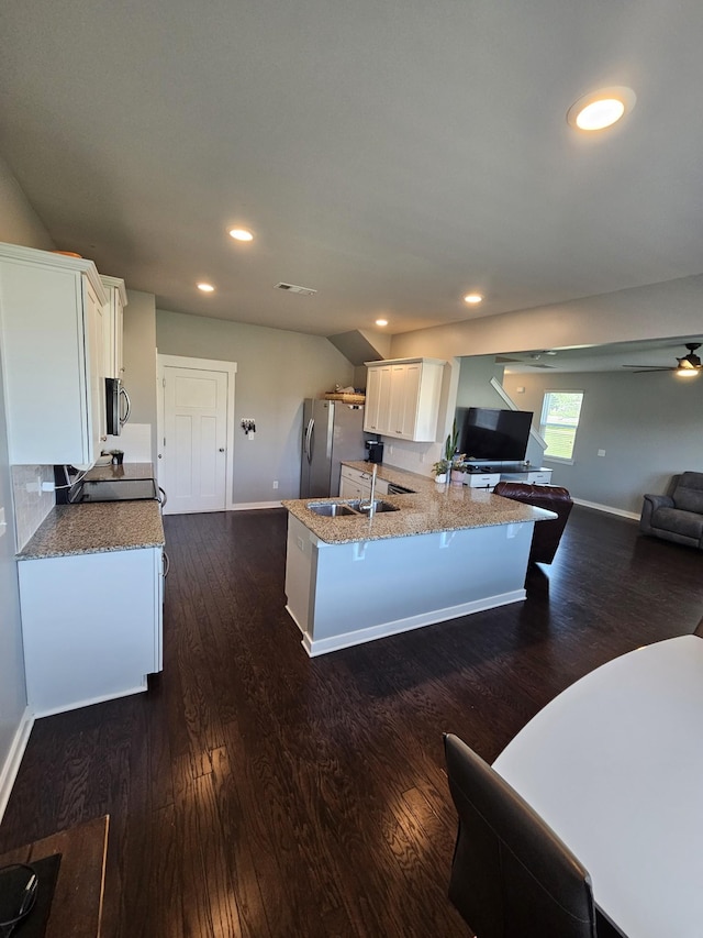 6005 Sentinel Dr, Spring Hill, TN 37174 - kitchen featuring white cabinetry, stainless steel appliances, dark wood-type flooring, light stone counters, and recessed lighting